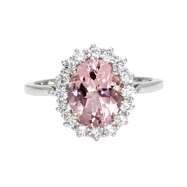 An oval natural pink Morganite engagement ring with a vintage inspired cluster design with a halo of diamonds in gold or platinum.