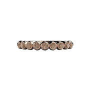 A cognac colored dark brown diamond band in a bezel set round bubble design wedding ring shown in rose gold.