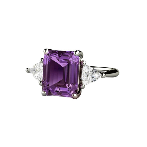 A large emerald cut Purple Sapphire engagement ring in a 3 stone style. A unique color-change sapphire three stone ring with sapphire trillions in gold or platinum.
