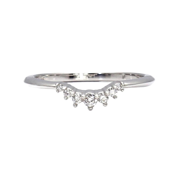 A contoured wedding ring with diamonds around the front that is curved to fit most solitaire engagement rings.
