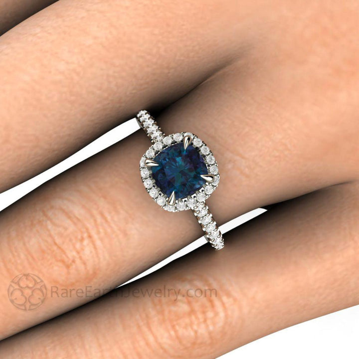 Close Up of Alexandrite Engagement Ring | Cushion Cut Color Changing Stone with Diamond Halo on the Finger