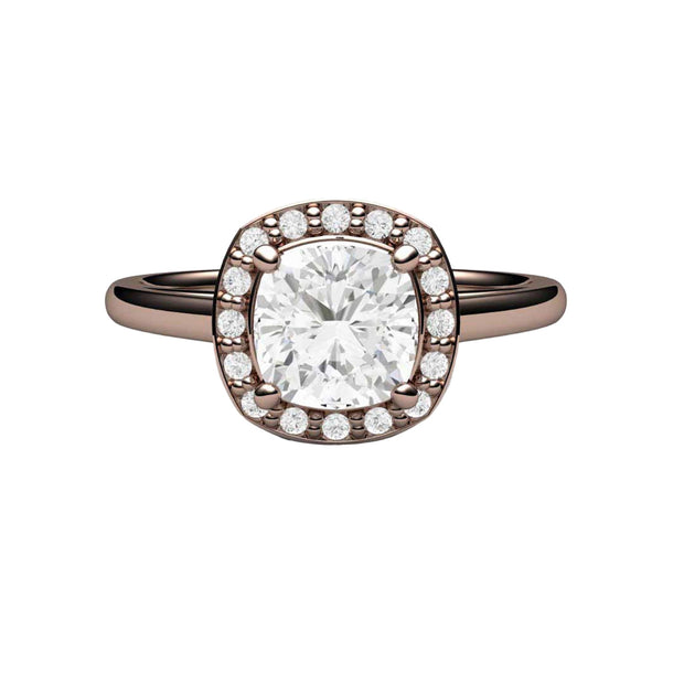 A diamond halo style ring in Moissanite.  This lab grown diamond alternative engagement ring has a Charles & Colvard Cushion Cut Forever One Moissanite surrounded by a pave set diamond halo on a plain rose gold band.
