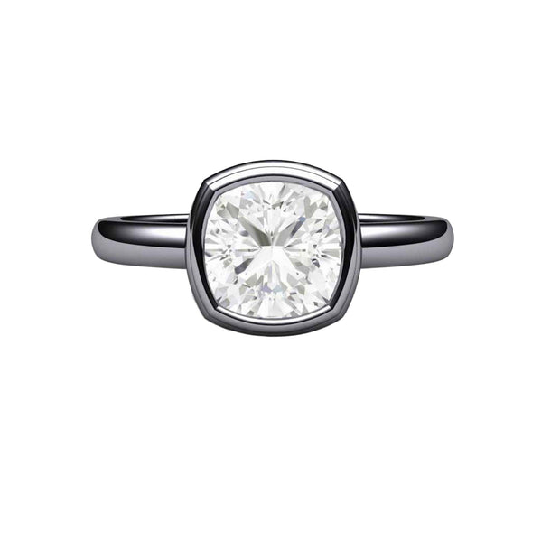 A Moissanite solitaire engagement ring in a simple bezel set design with a square cushion cut Charles & Colvard Forever One Moissanite center and a minimalist style with a plain band in gold or platinum.
