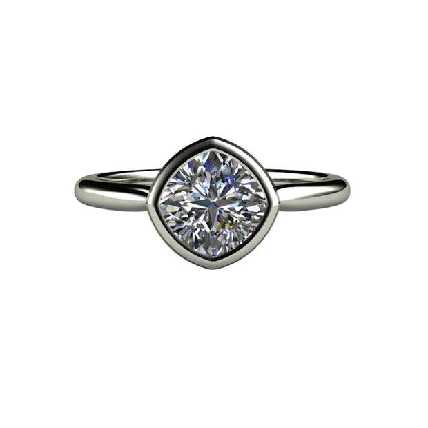 A cushion cut Moissanite engagement ring in a simple bezel-set solitaire design with a 1.20ct cushion cut Charles & Colvard Forever One Moissanite.