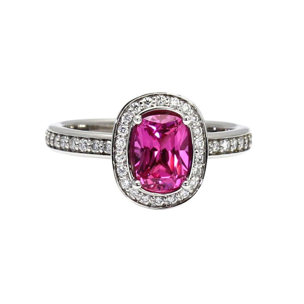 A cushion cut natural pink Sapphire ring with diamond halo, a unique hot candy pink engagement ring or right hand ring in gold or platinum from Rare Earth Jewelry.