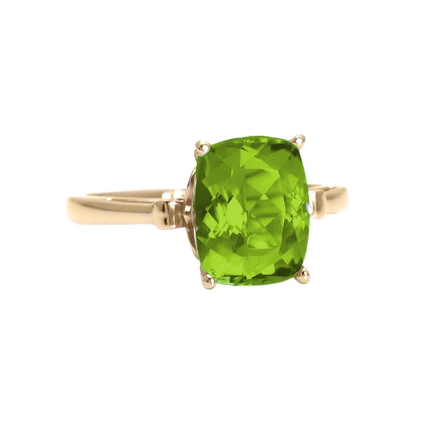 A large natural Peridot ring in a cushion cut solitaire setting with a Fleur de Lis design in 14K or 18K Gold. An August birthstone ring.