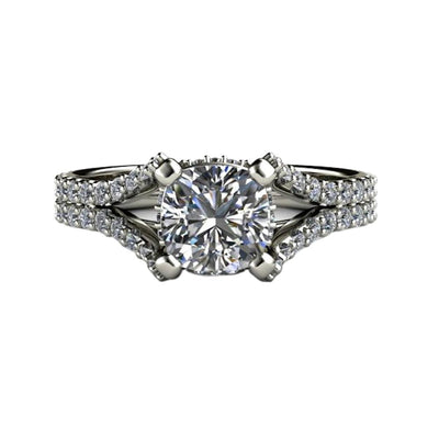 A Moissanite cushion engagement ring with a split shank double band and pave diamonds in gold or platinum.