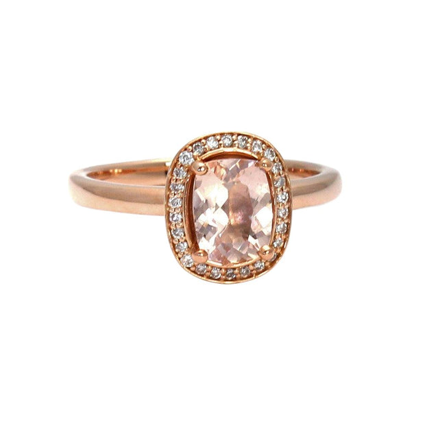 A cushion cut Morganite halo engagement ring with diamond halo on a plain rose gold shank.