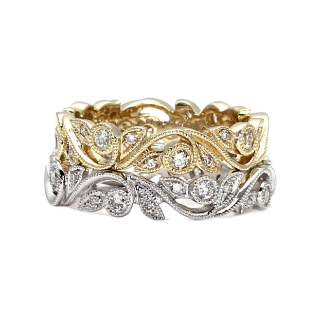 A nature inspired diamond eternity band or wedding ring with an openwork leaf design and milgrain beaded edges in gold or platinum.