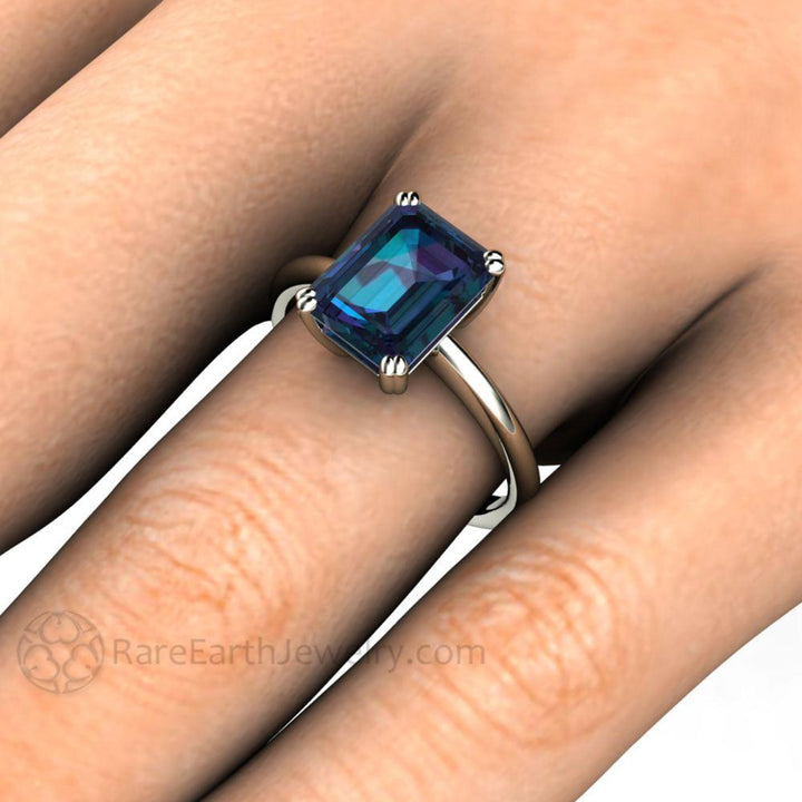 Close-up of Alexandrite Solitaire Ring on the Finger | 2.75ct Emerald Cut Engagement Ring on the Hand