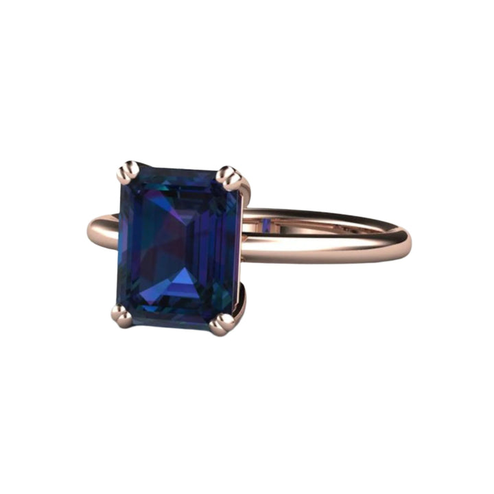 Lab Created Alexandrite Ring with Double Prong Solitaire Setting | Unique Engagement Ring with Emerald Cut Color Change Stone Shown in Rose Gold from Rare Earth Jewelry.