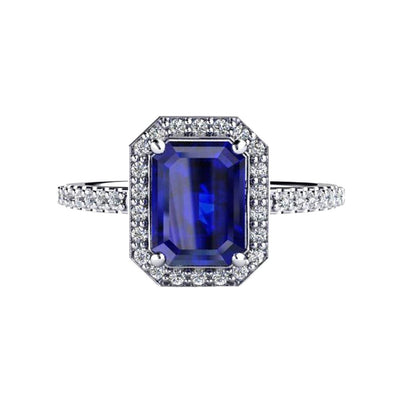An emerald cut Blue Sapphire engagement ring with pave set diamond halo and accented shank in gold or platinum from Rare Earth Jewelry.