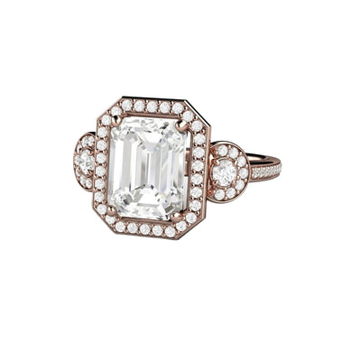A Moissanite engagement ring with a 9x7mm emerald cut Forever One Moissanite in a three stone diamond halo setting in gold or platinum from Rare Earth Jewelry.