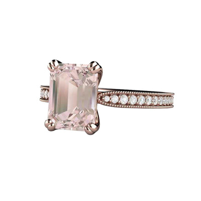 An emerald cut pink Morganite engagement ring in a vintage style solitaire design with pave diamond accents, milgrain beaded edge details and double prongs, available in gold or platinum, shown in rose gold from Rare Earth Jewelry.