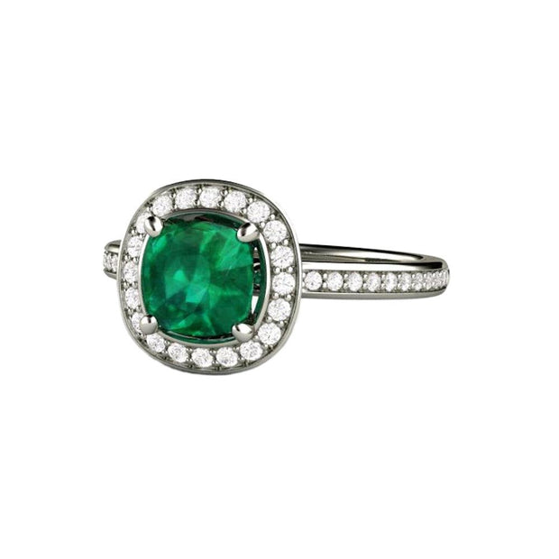 An emerald engagement ring with a cushion cut Lab created green emerald and a diamond halo design in gold or platinum from Rare Earth Jewelry.