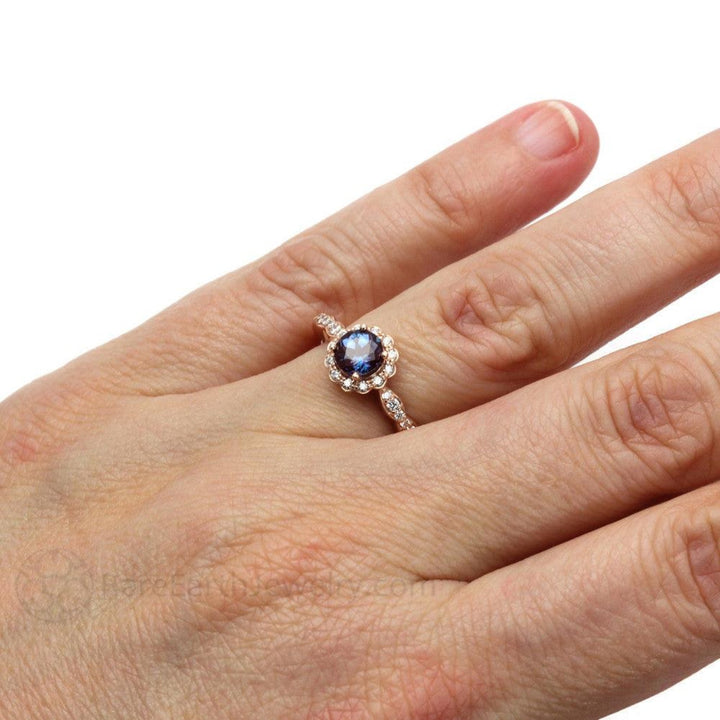 A feminine Alexandrite Engagement Ring with Scalloped Halo shown on the Hand, Alexandrite ring features a unique gemstone that changes color!