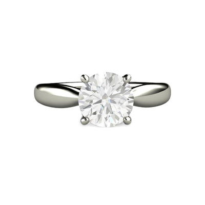 A classic four prong solitaire engagement ring with a stylish tapered shank and a 7.5mm round Charles & Colvard Forever One Moissanite, an affordable and ethical diamond alternative. Available in gold or platinum from Rare Earth Jewelry.