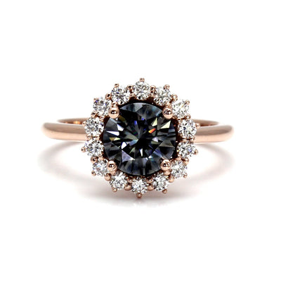 A round gray moissanite enagement ring with a vintage style cluster halo design in gold or platinum, shown in rose gold from Rare Earth Jewelry.