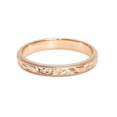 A hand engraved wedding ring in gold, a vintage style wedding band with a flower design from Rare Earth Jewelry.