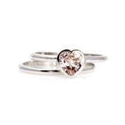 A heart shaped Morganite ring with a heart cut natural Morganite in a bezel setting, a unique solitaire engagement ring and matching wedding band in gold or platinum from Rare Earth Jewelry.