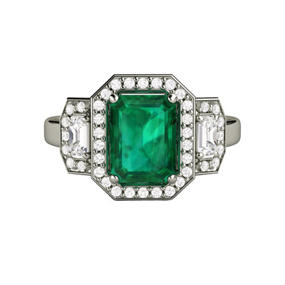 A large lab created emerald and diamond engagement ring in a 3 stone style with diamond halos and an emerald cut lab grown Emerald in gold or platinum, unique engagement ring from Rare Earth Jewelry.