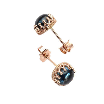 A pair of natural London Blue Topaz earrings with round cabochon cut Blue Topaz in 14K Gold crown design studs, unique December birthstone earrings from Rare Earth Jewelry.