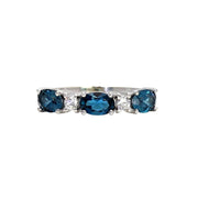 A natural London Blue Topaz ring with oval shaped natural London Blue Topaz set in a unique east to west orientation with diamonds. This December birthstone ring is available in gold or platinum and is great for stacking. Exclusively from Rare Earth Jewelry.