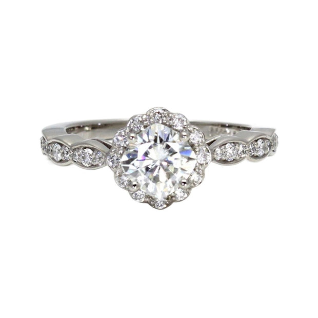 A vintage style moissanite cushion cut engagement ring with diamond halo and feminine scalloped band available in gold or platinum from Rare Earth Jewelry.