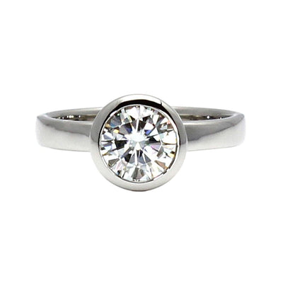 1 ct bezel set Moissanite engagement ring in a minimalist solitaire design with a Charles & Colvard Forever One Moissanite, a eco-friendly diamond alternative from Rare Earth Jewelry.