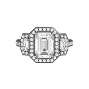 A three stone emerald cut Forever One Moissanite engagement ring surrounded by sparkling diamond halos in gold or Platinum from Rare Earth Jewelry.