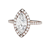A marquise cut Moissanite engagement ring with pave set diamond halo, dainty feminine style with Forever One Moissanite, a lab created diamond alternative from Rare Earth Jewelry.
