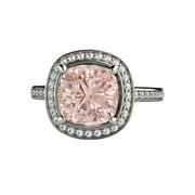 A natural Morganite engagement ring in a cushion cut diamond halo design with diamond accented band in gold or platinum.