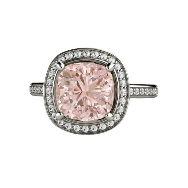 A natural Morganite engagement ring in a cushion cut diamond halo design with diamond accented band in gold or platinum.