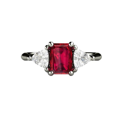 An emerald cut natural Ruby engagement ring with diamond trillions in a classic three stone setting available in gold or platinum from Rare Earth Jewelry.
