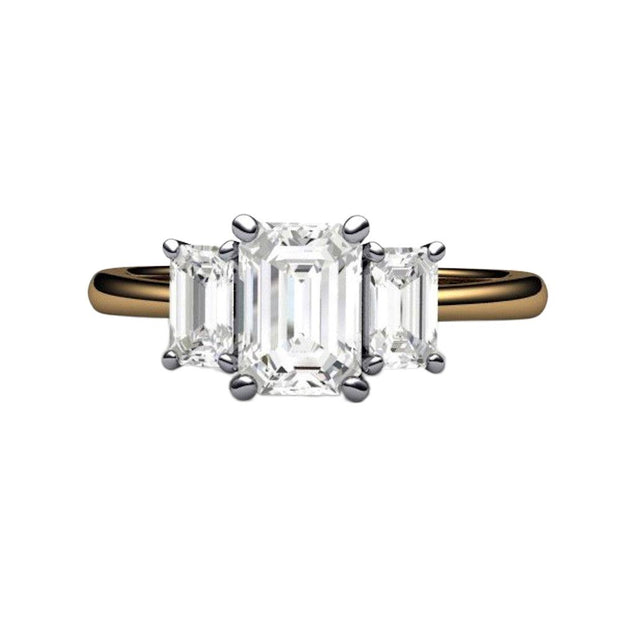 A natural White Sapphire engagement ring in a three stone style with 3 emerald cut white sapphires in a two-tone gold and platinum setting, a classic design from Rare Earth Jewelry.