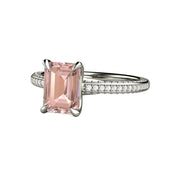 An emerald cut light Pink Sapphire engagement ring in a pave diamond solitaire design with a pink champagne Chatham lab created Sapphire.