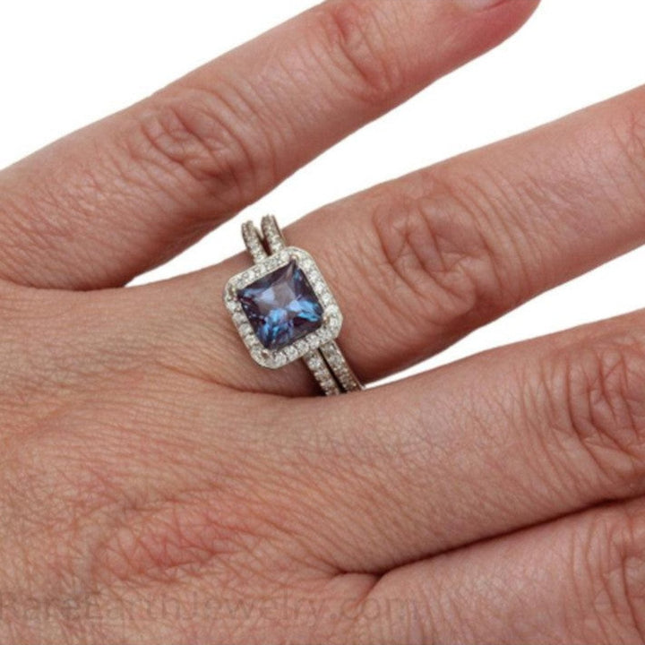 Princess Cut Alexandrite Bridal Set, engagement ring with square diamond halo and matching diamond band, shown on the hand.