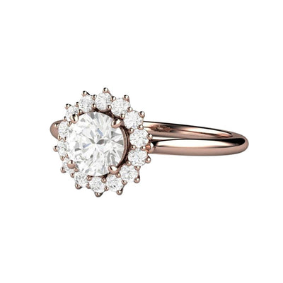 A vintage style diamond engagement ring with a .75ct round GIA Certified colorless natural diamond and a cluster style halo design in gold or platinum, shown in rose gold.