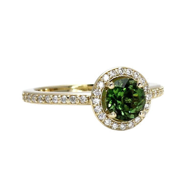 A round natural green Tourmaline ring with diamond halo and diamond accented shank, shown in yellow gold from Rare Earth Jewelry.