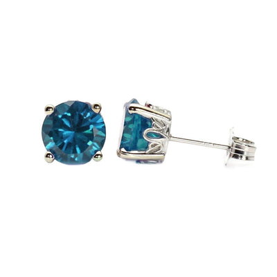 A pair of natural London Blue Topaz earrings in floral design settings, 14K Gold December birthstone studs from Rare Earth Jewelry.