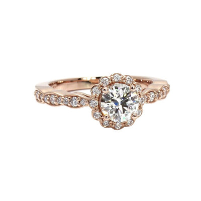 A round Charles & Colvard Forever One Moissanite halo engagement ring with a feminine vintage inspired design and a pretty scalloped band in gold or platinum from Rare Earth Jewelry.,