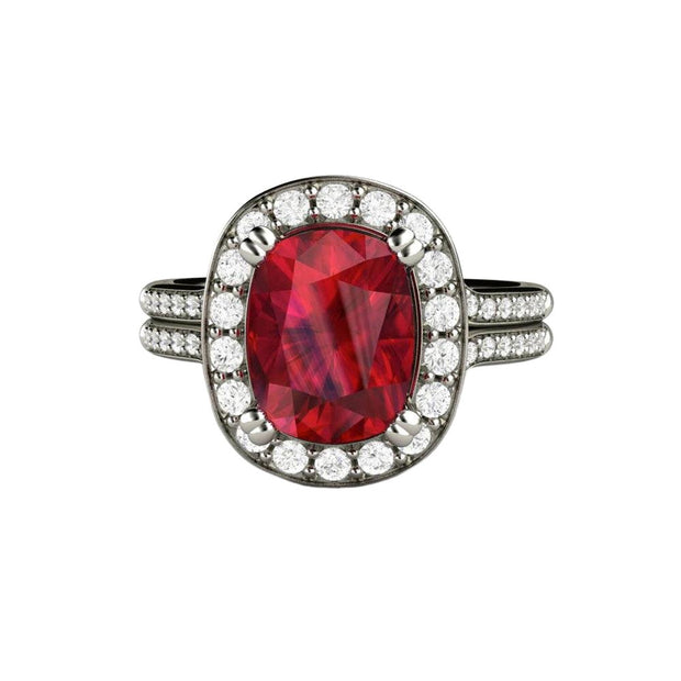 A large cushion cut Ruby and diamond ring with a diamond halo and a split shank double band design in gold or platinum from Rare Earth Jewelry..