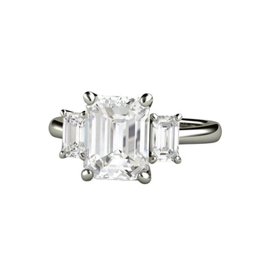 A three stone emerald cut Moissanite engagement ring with Charles & Colvard Forever One Moissanite, an elegant and affordable diamond alternative in gold or platinum from Rare Earth Jewelry.