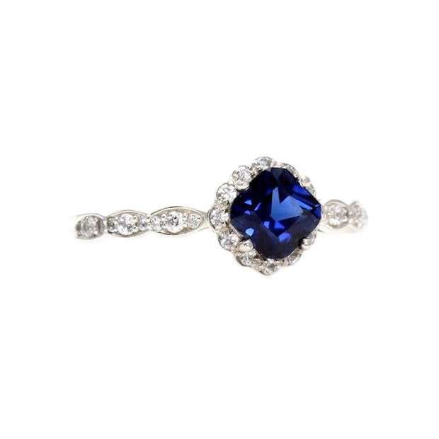 A vintage style Blue Sapphire engagement ring with a 1 carat asscher cut lab grown Blue Sapphire with diamond accents from Rare Earth Jewelry.