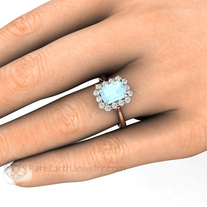 Emerald Cut Natural Aquamarine Engagement Ring with Diamond Cluster on the Hand Photo