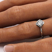 Bezel Set Cushion Cut Engagement Ring with Forever One Moissanite Simple Solitaire on the Hand Shot - Rare Earth Jewelry