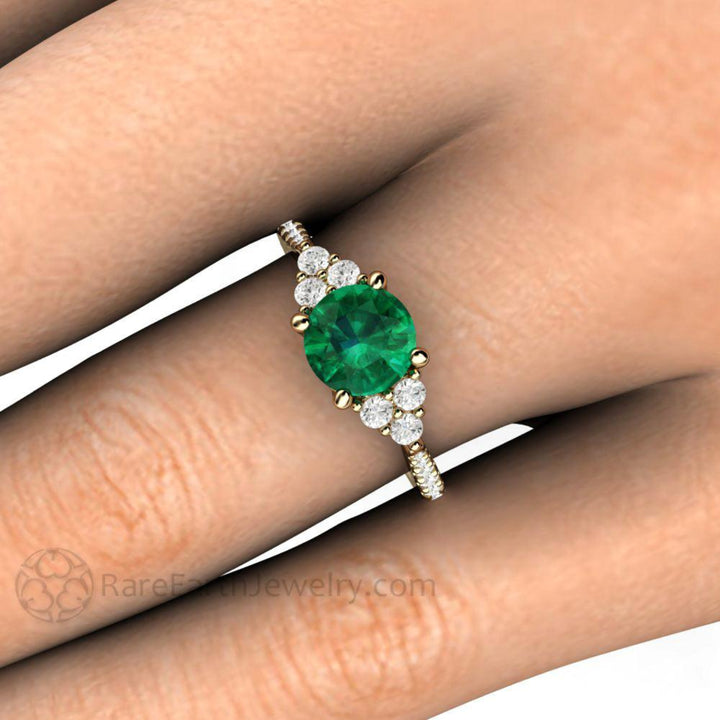 Round Emerald Engagement Ring on the Finger, French Pave Diamond Cluster Setting | Rare Earth Jewelry
