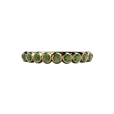 a unique round green diamond bezel set wedding band or stackable ring, shown here in yellow gold.