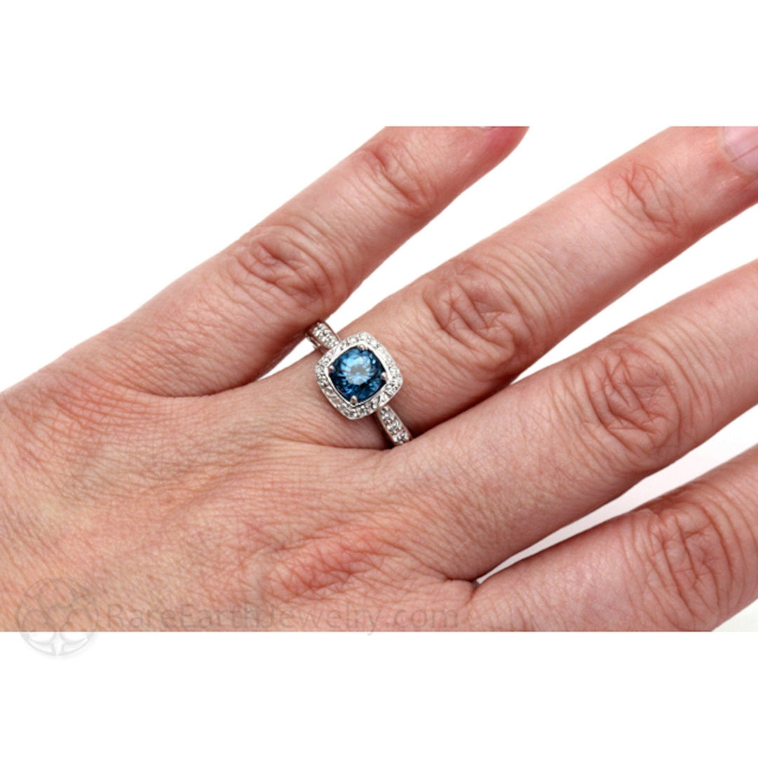 Cushion Cut London Blue Topaz Ring with Halo and Diamonds on Model’s Hand | Elegant Vintage Style Engagement Ring | Rare Earth Jewelry