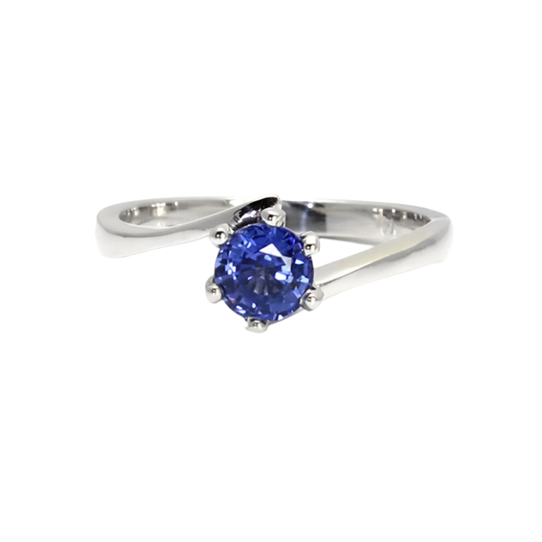 Close-up of 6-prong solitaire sapphire engagement ring in white gold with bypass shank | Rare Earth Jewelry